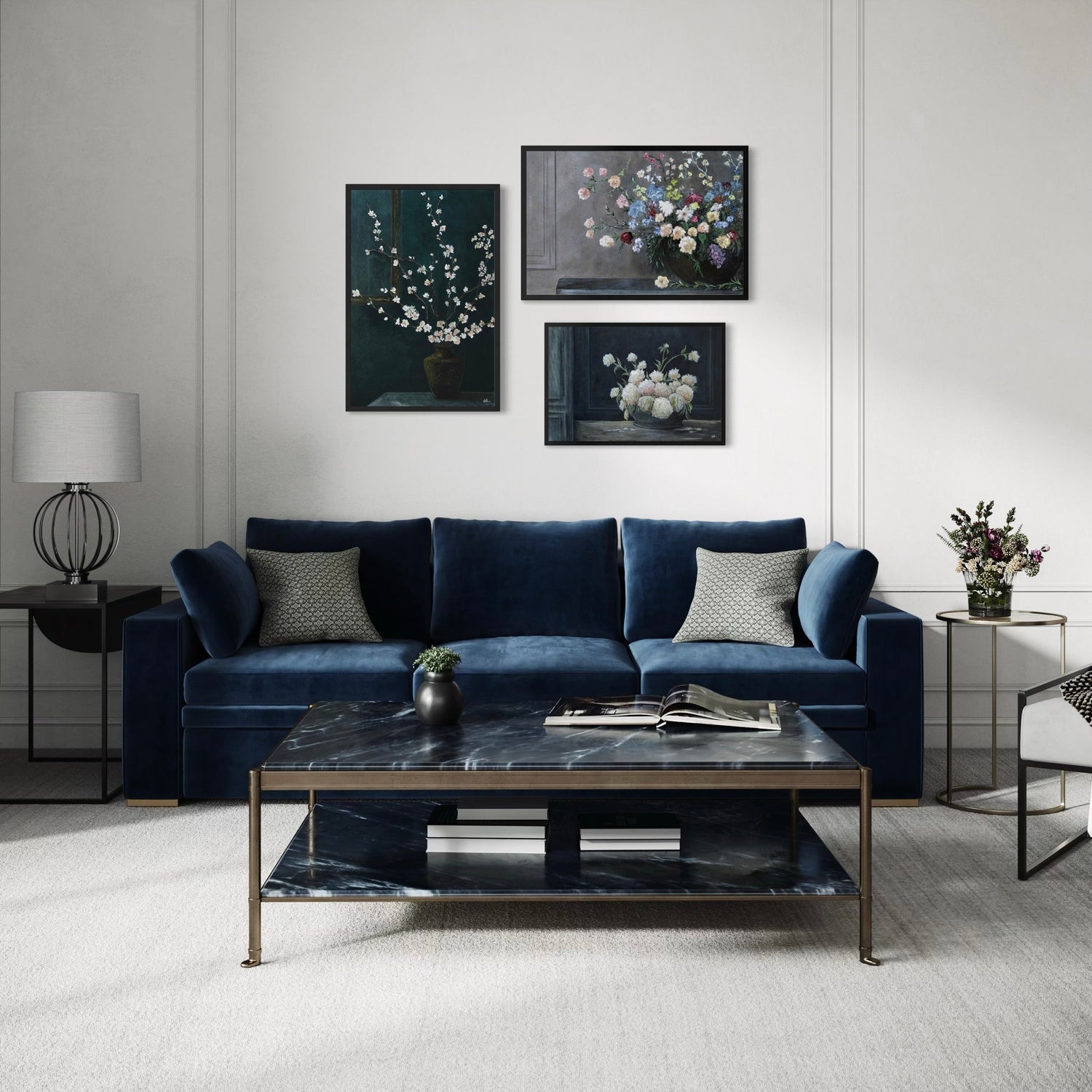 Three moody floral paintings above a blue couch and black marble coffee table.