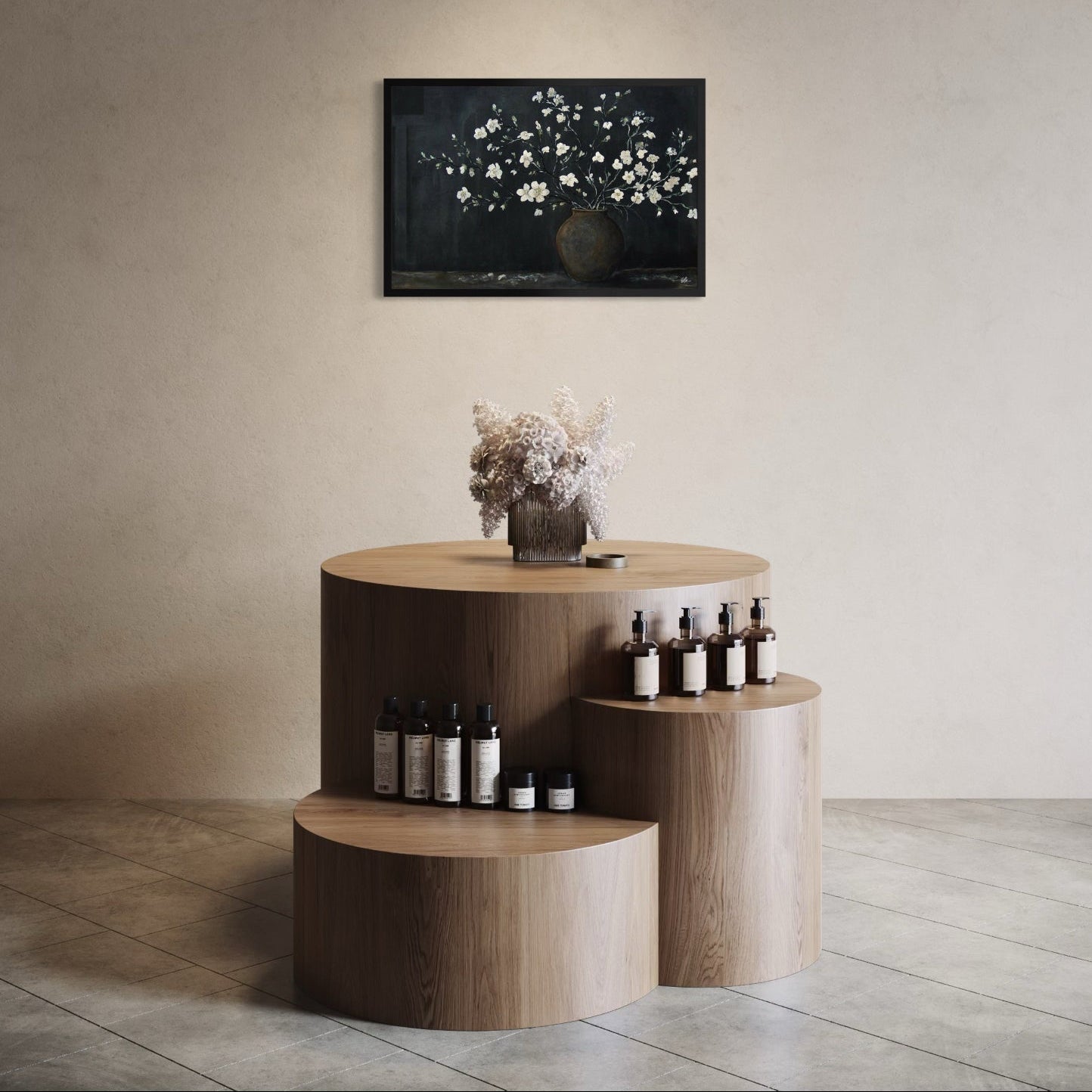 Wooden display unit with bottles against a beige wall with a framed picture.
