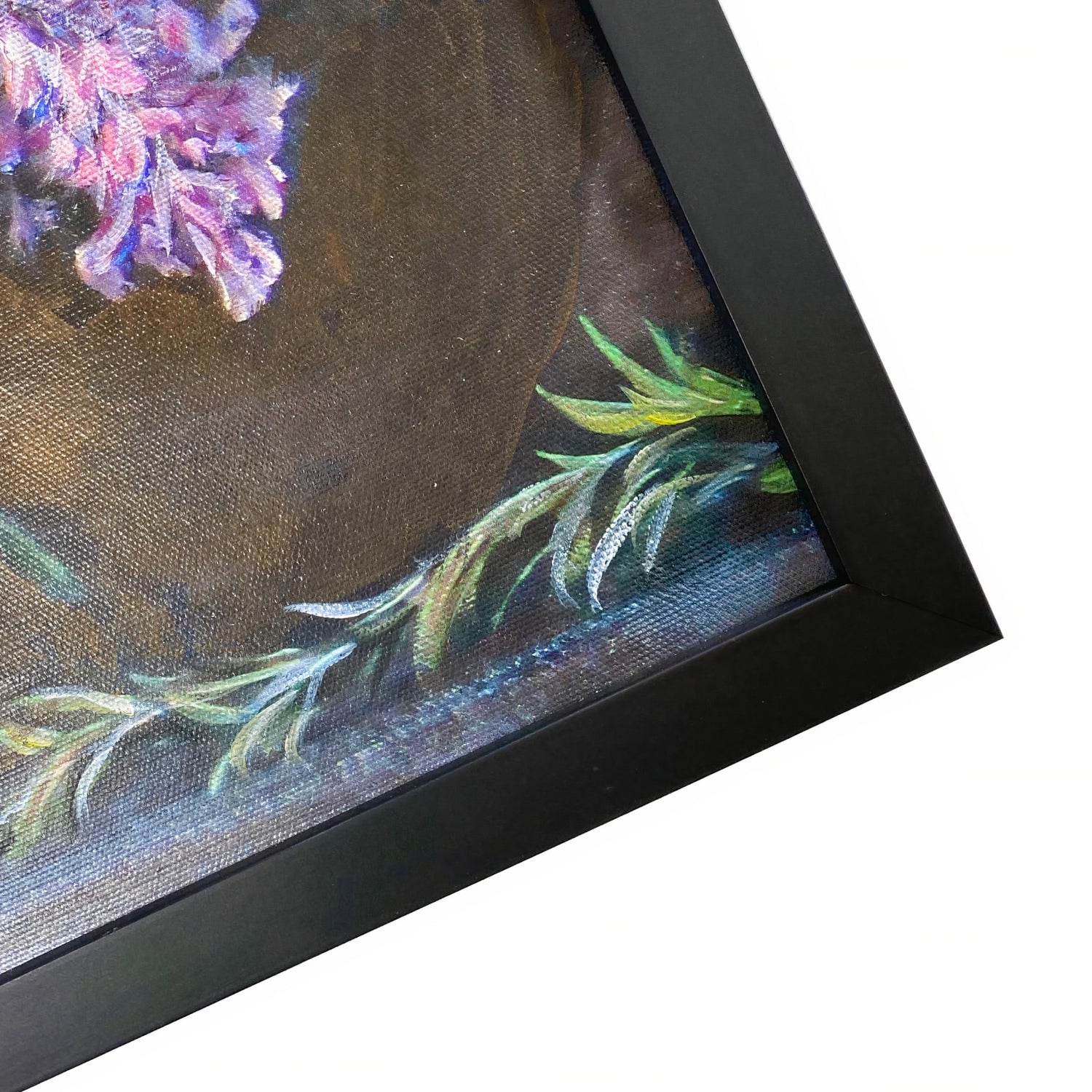 Close-up of a framed painting with purple flowers and green leaves on a white background