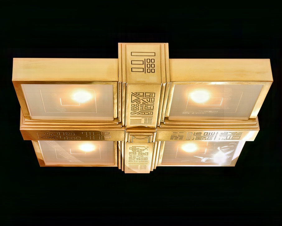 Gold ceiling light fixture with intricate design on a black background