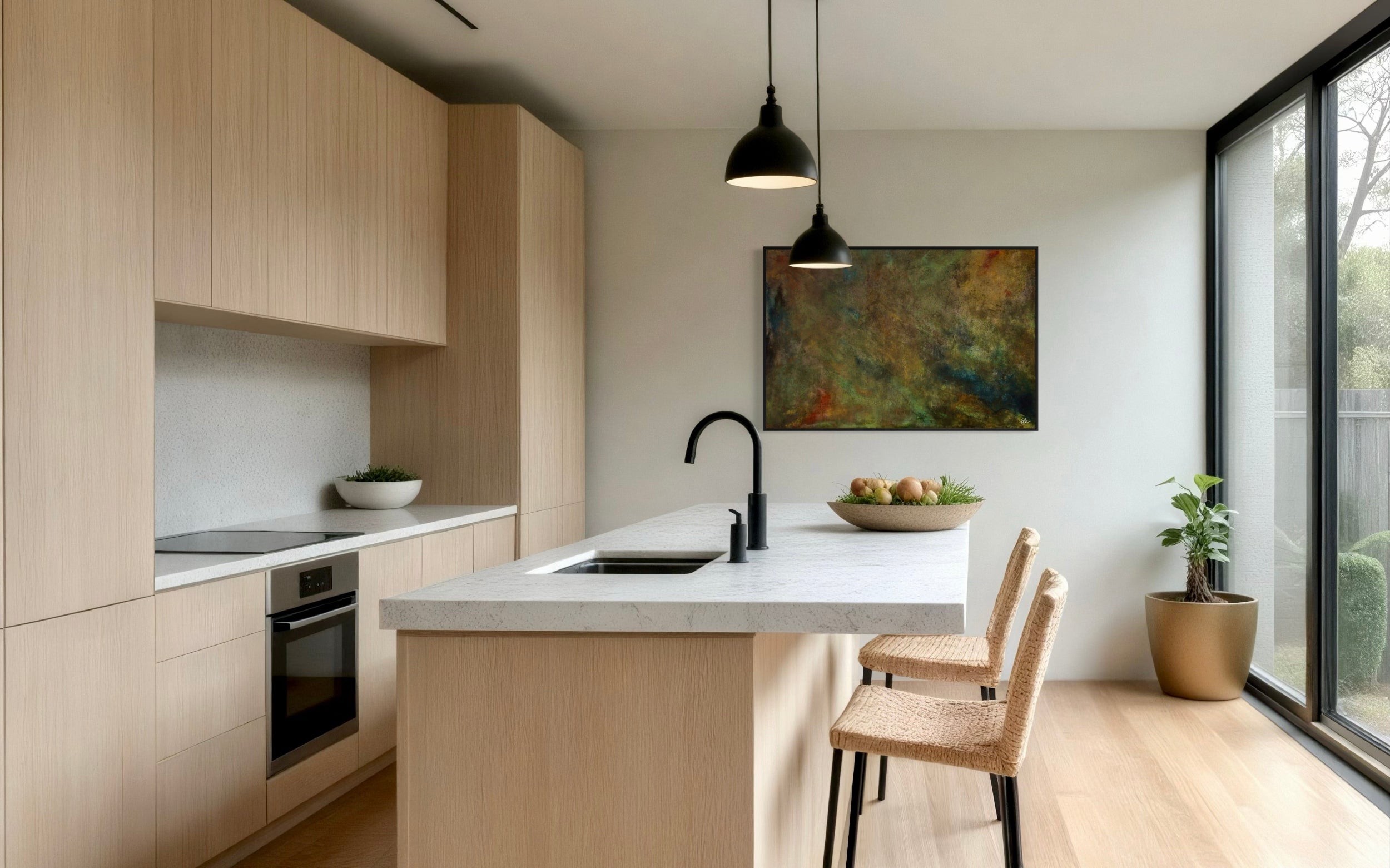 Modern kitchen with light wood cabinets, white countertops, and a painting on the wall.