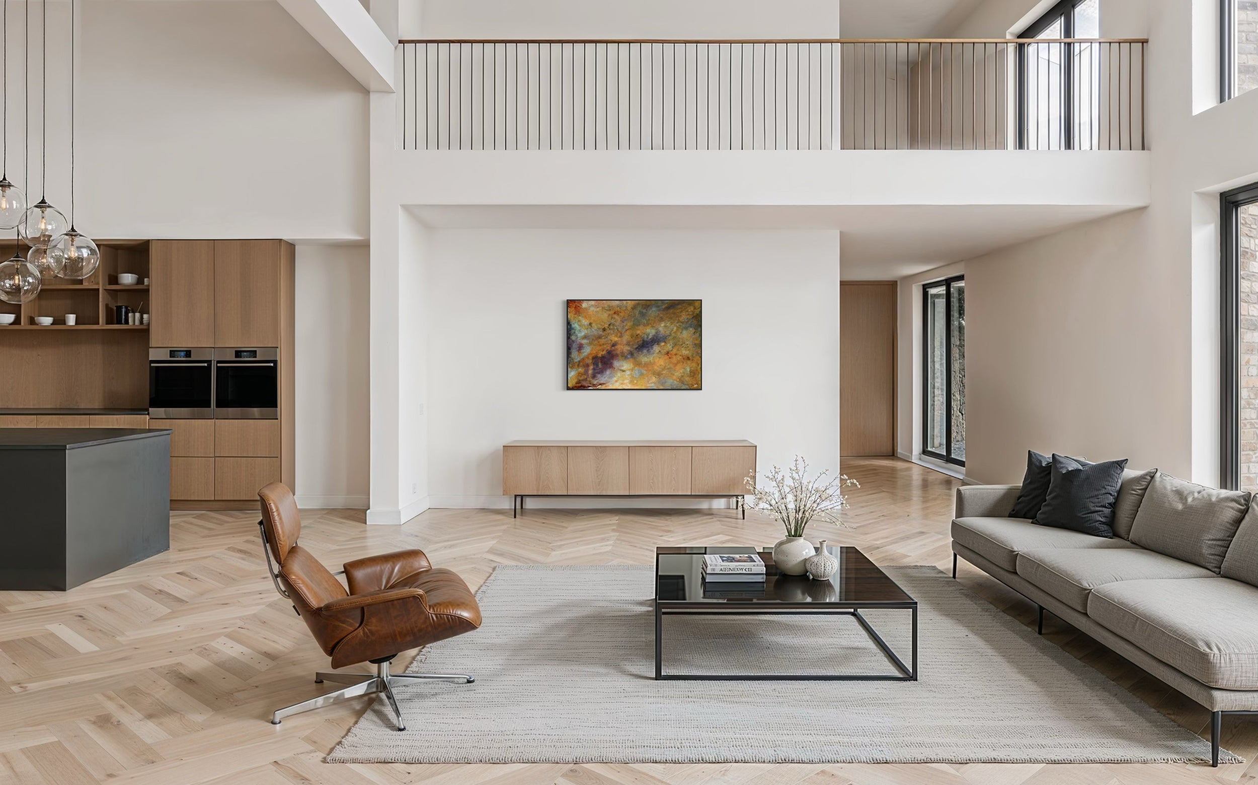 Spacious modern interior featuring an abstract painting on a wall above a wooden sideboard.