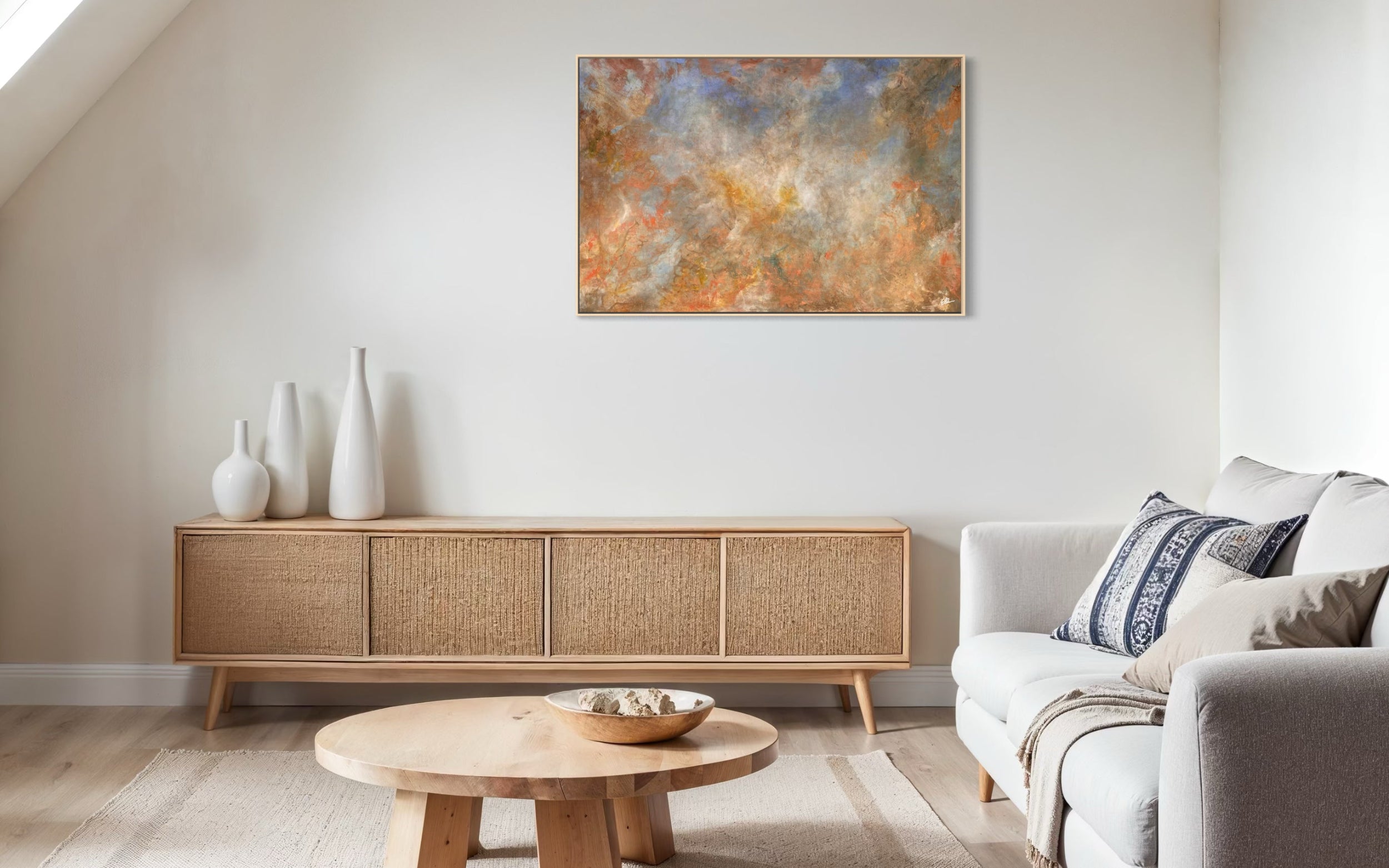 Modern living room with a wooden sideboard, white sofa, and abstract painting on the wall.