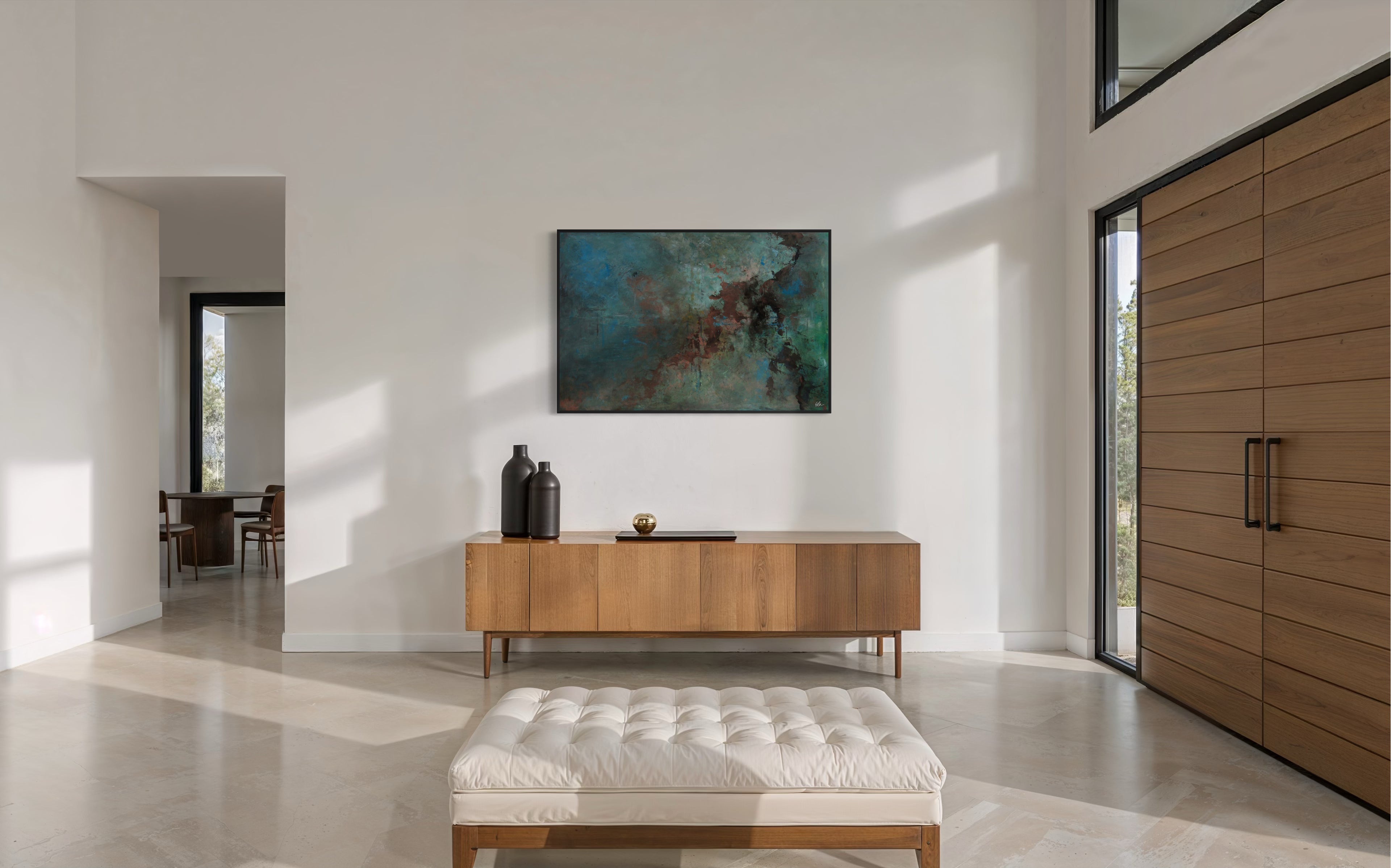 Large abstract painting in the entry of a spacious modern home.