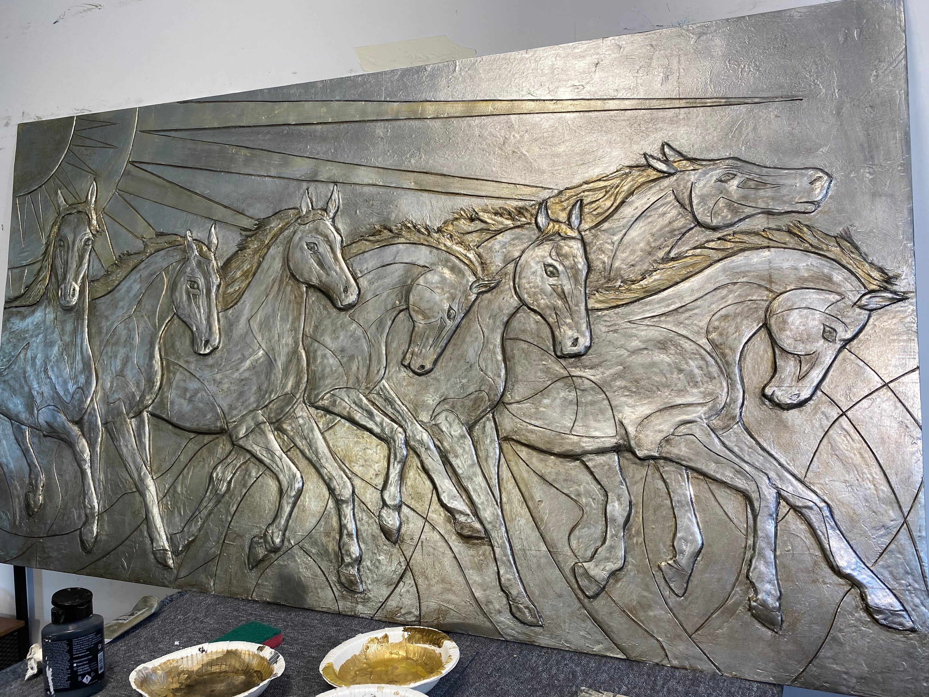 Bronze sculpted artwork of 7 horses running