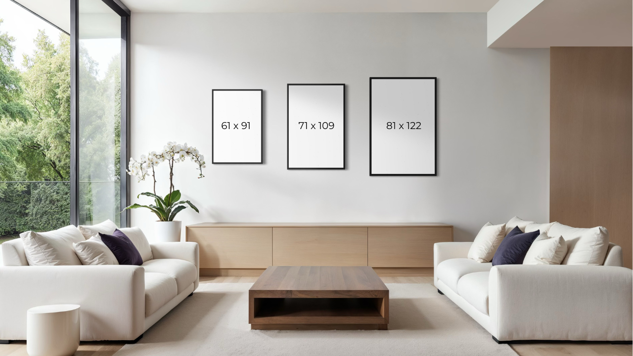 Modern living room with white sofas, a wooden coffee table, and framed pictures on the wall.